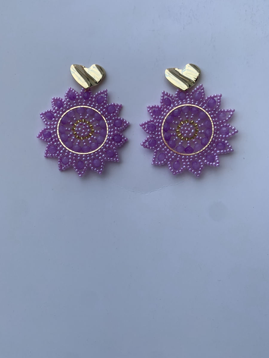 Round lavender mandala disc earrings with faceted crystal accents in soft purple tones and hammered gold heart stud.