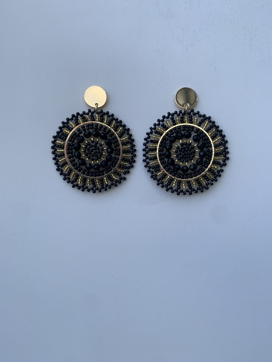 Large circular black mandala disc earrings with concentric bead rings, faceted crystal centre, and gold post stud.