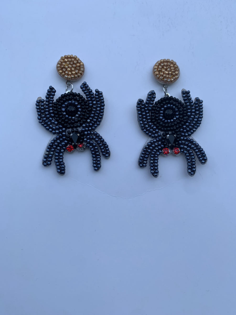Beaded spider earrings with eight black legs, faceted black body, red crystal accent centre, and gold round stud top.