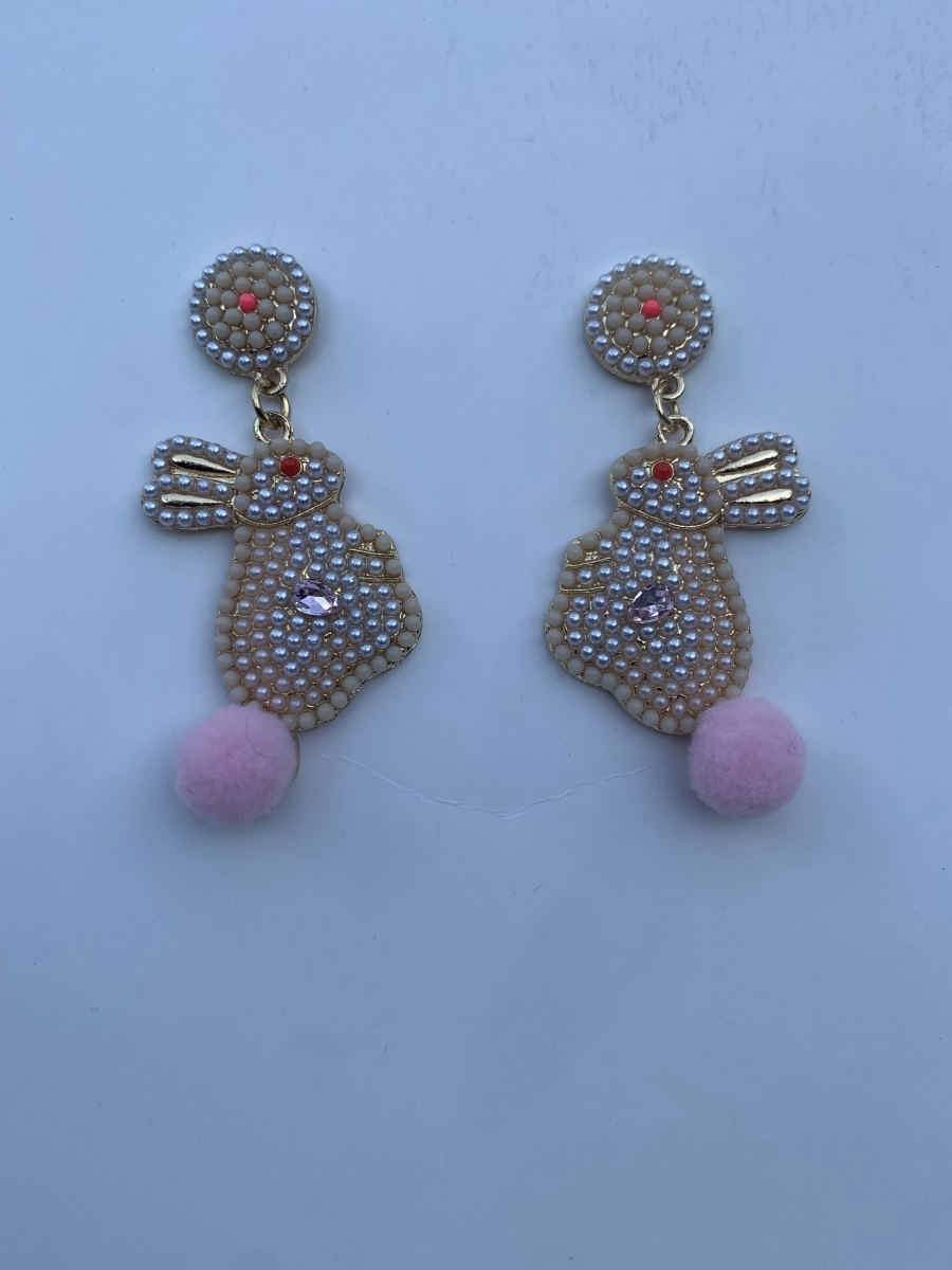 Beaded bunny rabbit earrings in pearl cream with crystal accents, pink pompom tail, and pearl stud on gold chain.