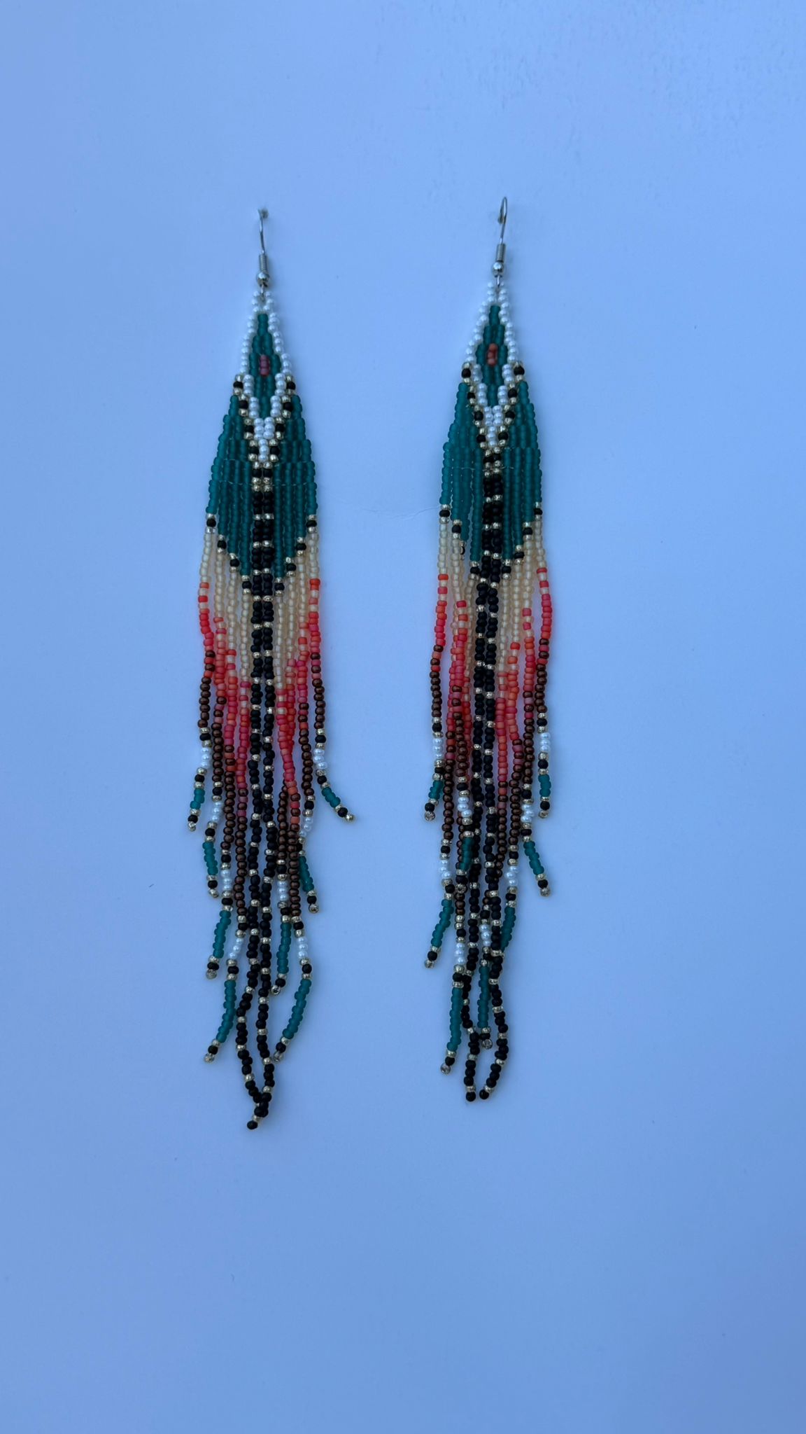 Pair of teal beaded fringe earrings with chevron tops and multicolored strands.