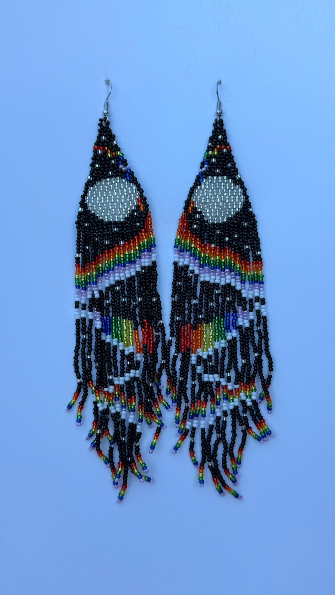 Pair of beaded drop earrings with crescent moon design in blue and multicolored gradient fringes